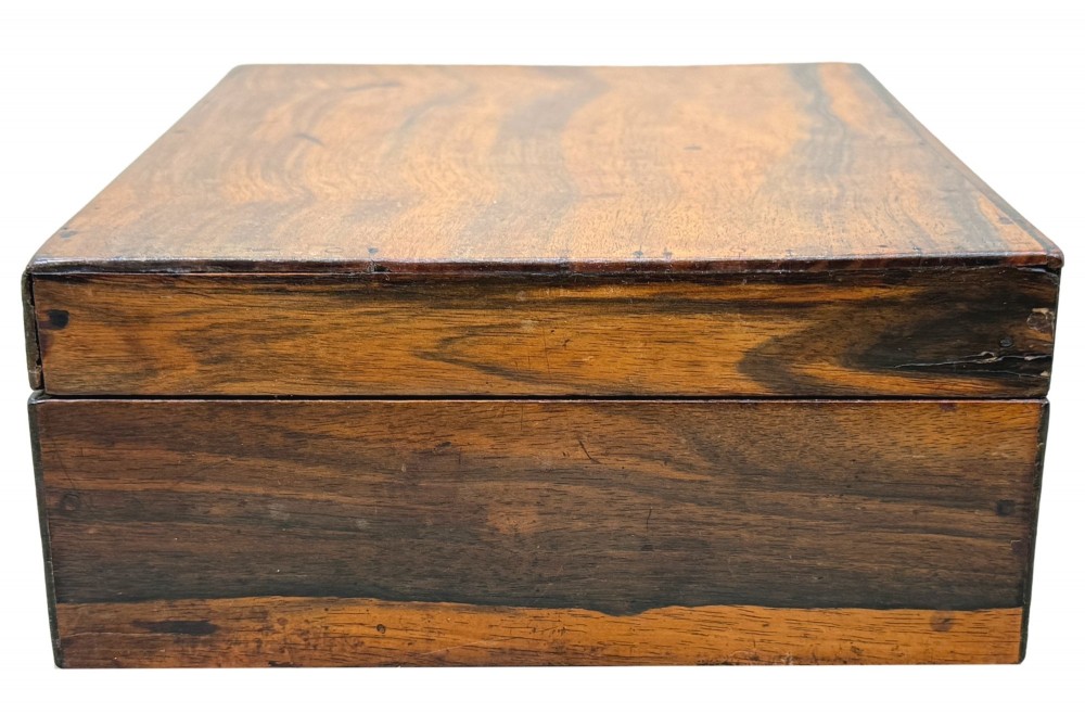 A 19th-century rectangular coromandel wood work box featuring a hinged lid, rich striped graining, and a central escutcheon. View II