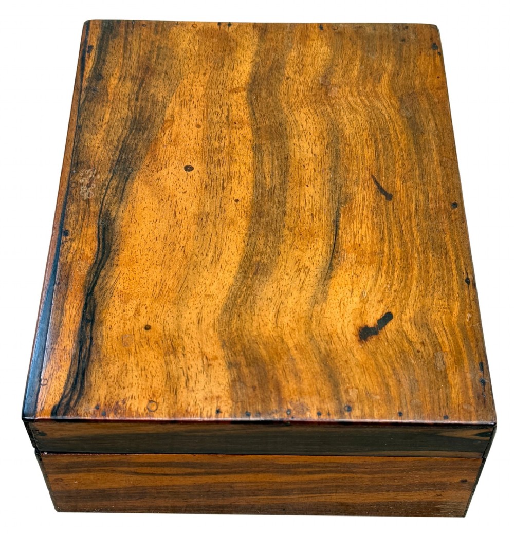 A 19th-century rectangular coromandel wood work box featuring a hinged lid, rich striped graining, and a central escutcheon. View III