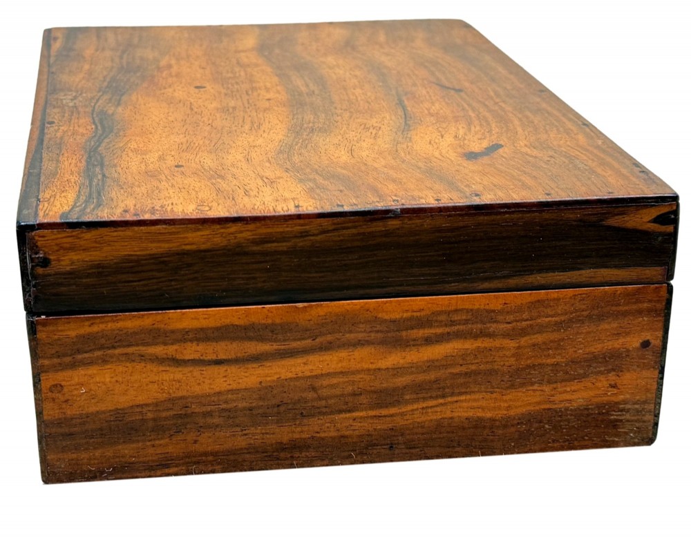 A 19th-century rectangular coromandel wood work box featuring a hinged lid, rich striped graining, and a central escutcheon. View IV