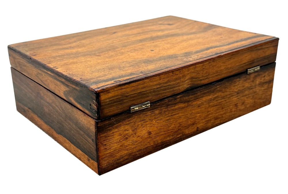 A 19th-century rectangular coromandel wood work box featuring a hinged lid, rich striped graining, and a central escutcheon. View VI