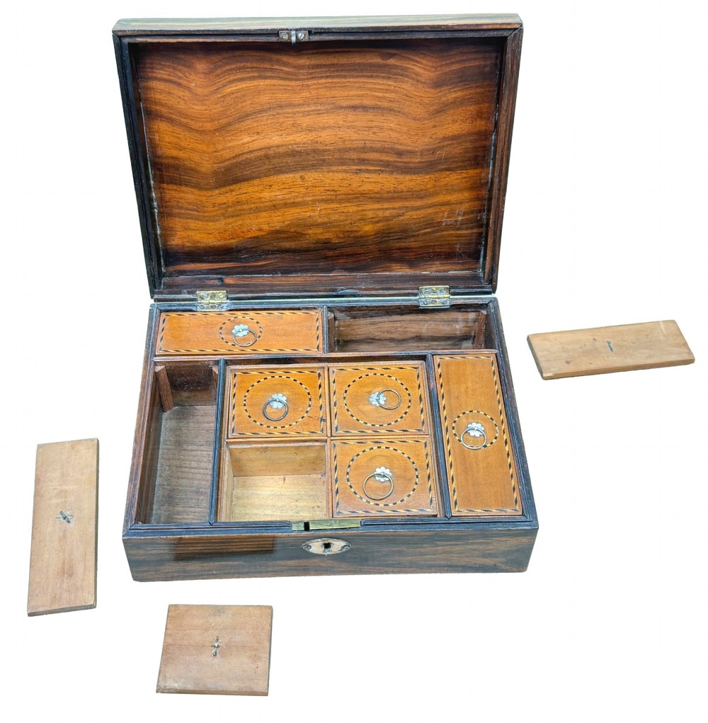A 19th-century rectangular coromandel wood work box featuring a hinged lid, rich striped graining, and a central escutcheon. View VII