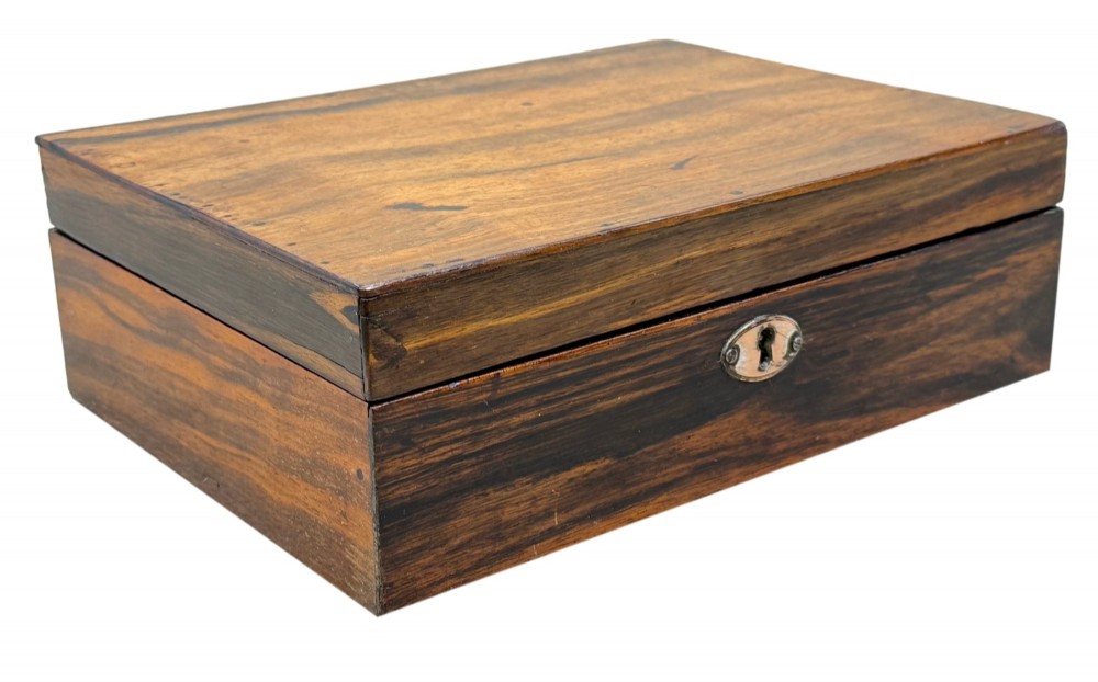 A 19th-century rectangular coromandel wood work box featuring a hinged lid, rich striped graining, and a central escutcheon. View IX