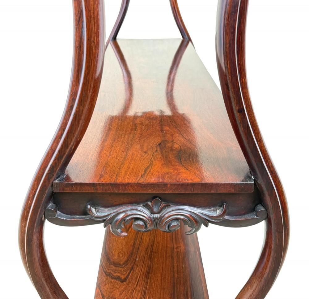 A mid-19th century three-tier rosewood standing buffet unit featuring curved leg supports and carved scroll details. View VI