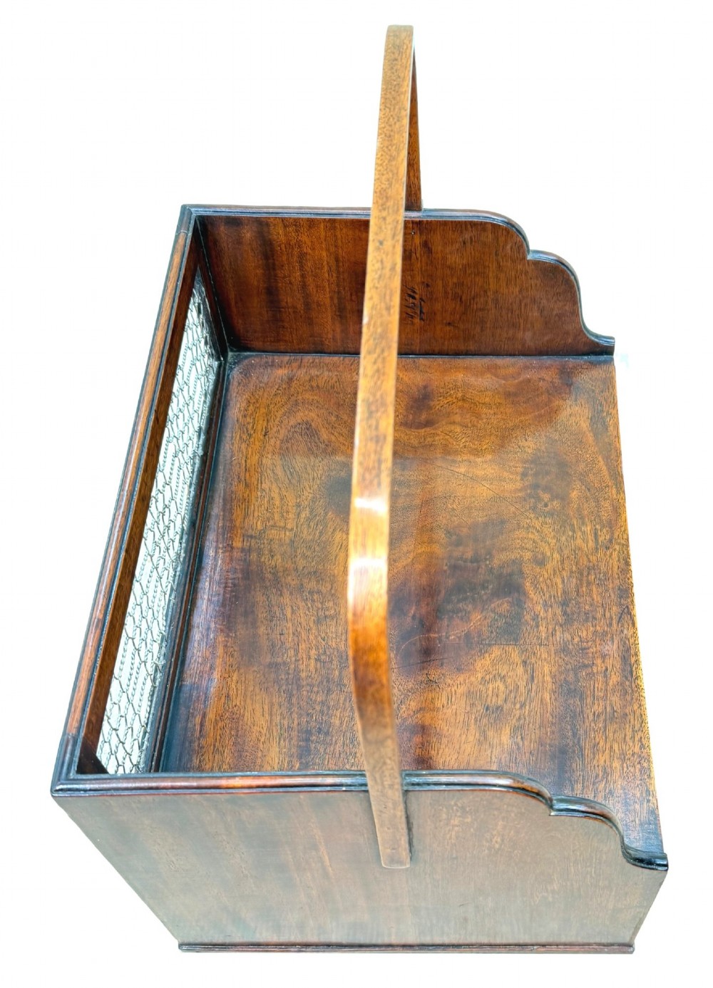An 18th-century Georgian mahogany book carrier featuring a curved wooden top handle, a rear wire mesh panel, shaped side galleries, and three small drawers fitted with brass drop ring handles. View III