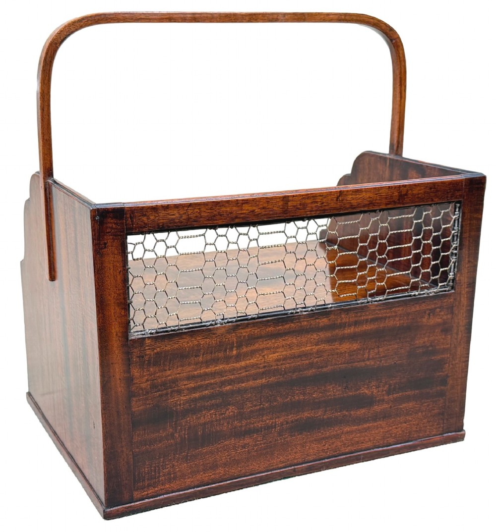 An 18th-century Georgian mahogany book carrier featuring a curved wooden top handle, a rear wire mesh panel, shaped side galleries, and three small drawers fitted with brass drop ring handles. View V