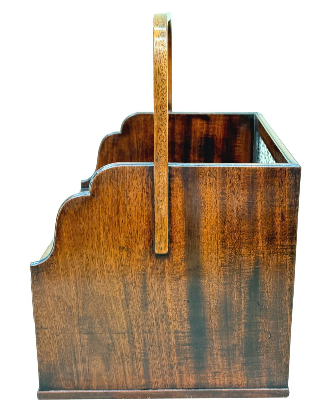 An 18th-century Georgian mahogany book carrier featuring a curved wooden top handle, a rear wire mesh panel, shaped side galleries, and three small drawers fitted with brass drop ring handles. View VI