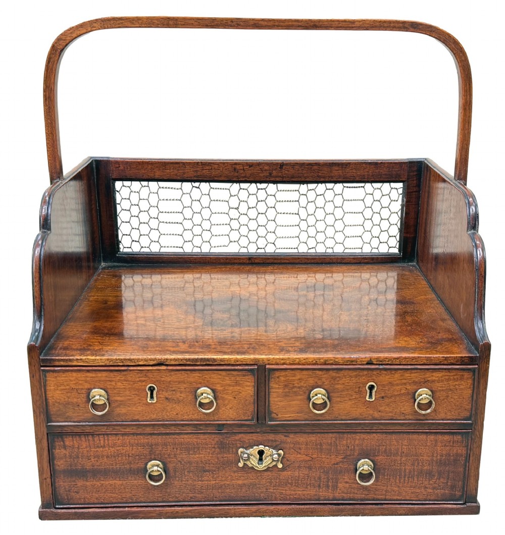 An 18th-century Georgian mahogany book carrier featuring a curved wooden top handle, a rear wire mesh panel, shaped side galleries, and three small drawers fitted with brass drop ring handles. View IX