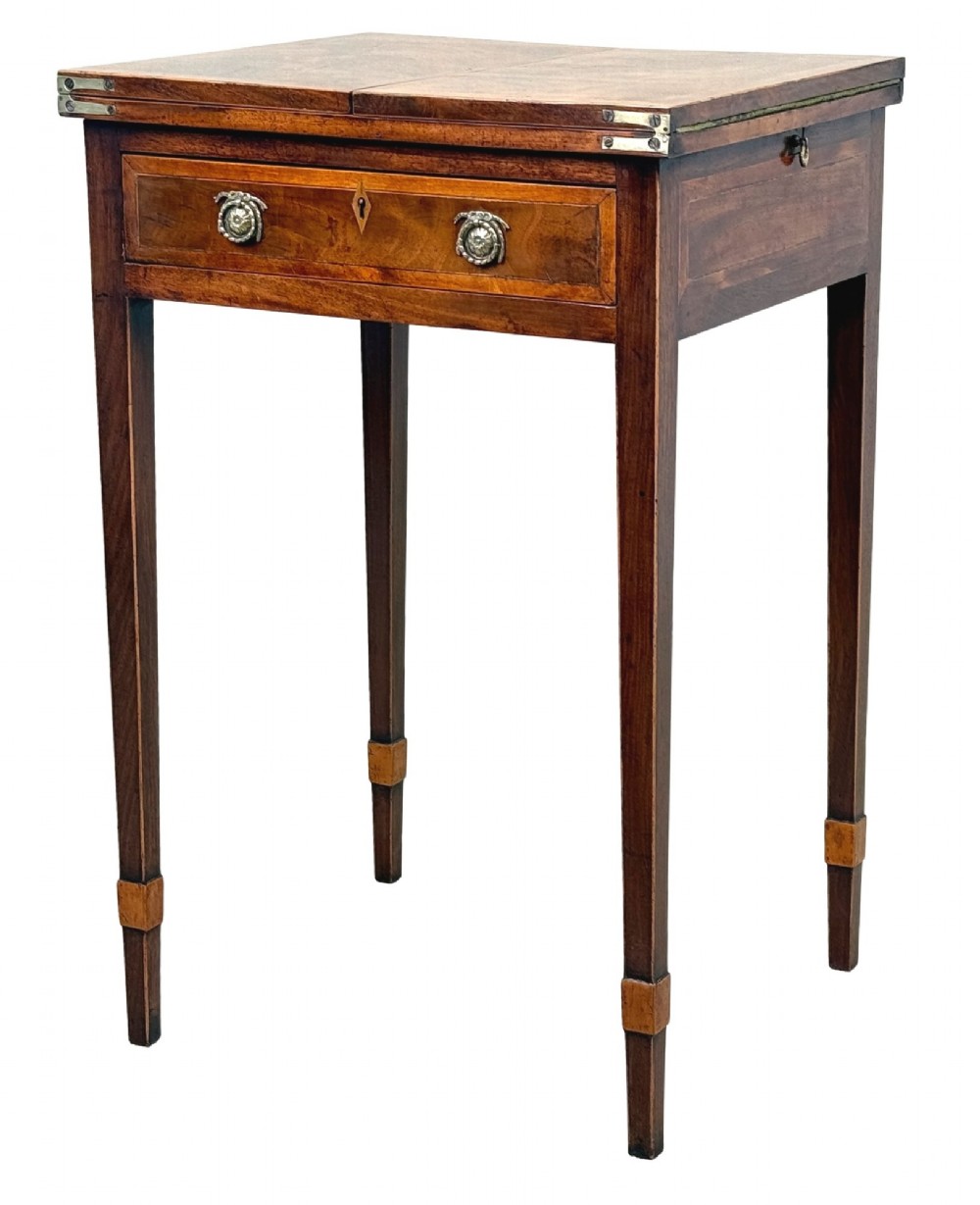 An 18th-century Georgian mahogany patience table featuring a folding top, brass corner brackets, a single drawer with ring handles, and square tapered legs.