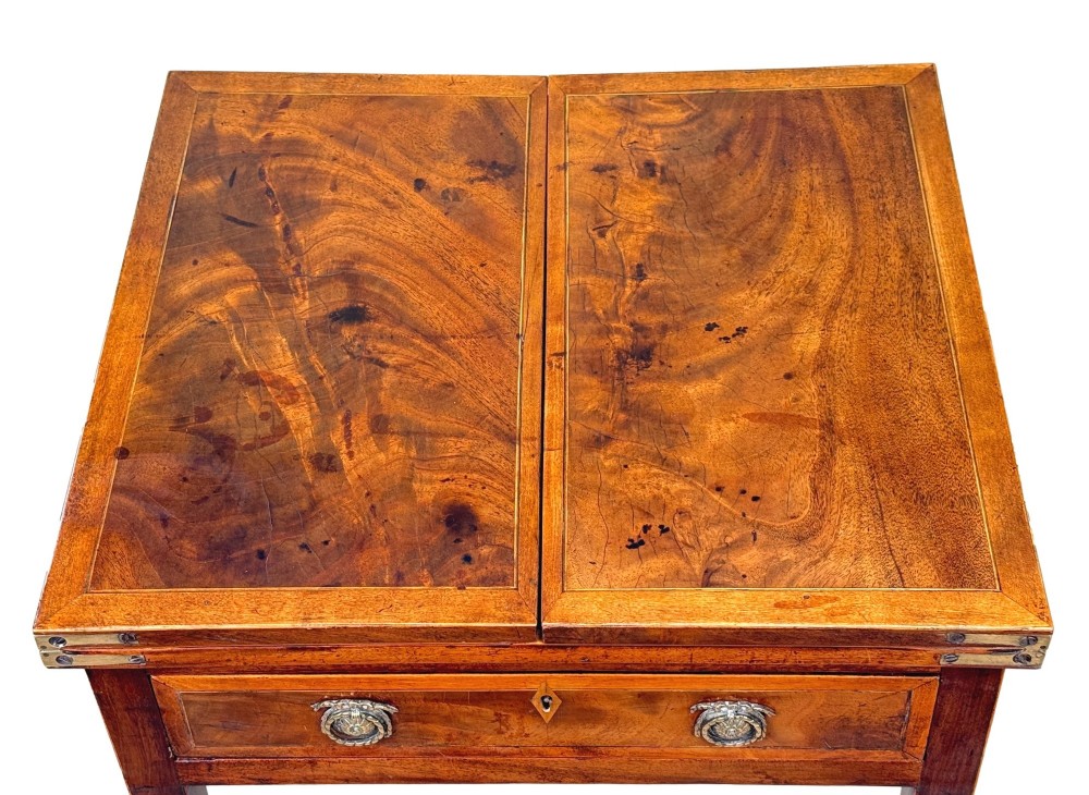 An 18th-century Georgian mahogany patience table featuring a folding top, brass corner brackets, a single drawer with ring handles, and square tapered legs. View III