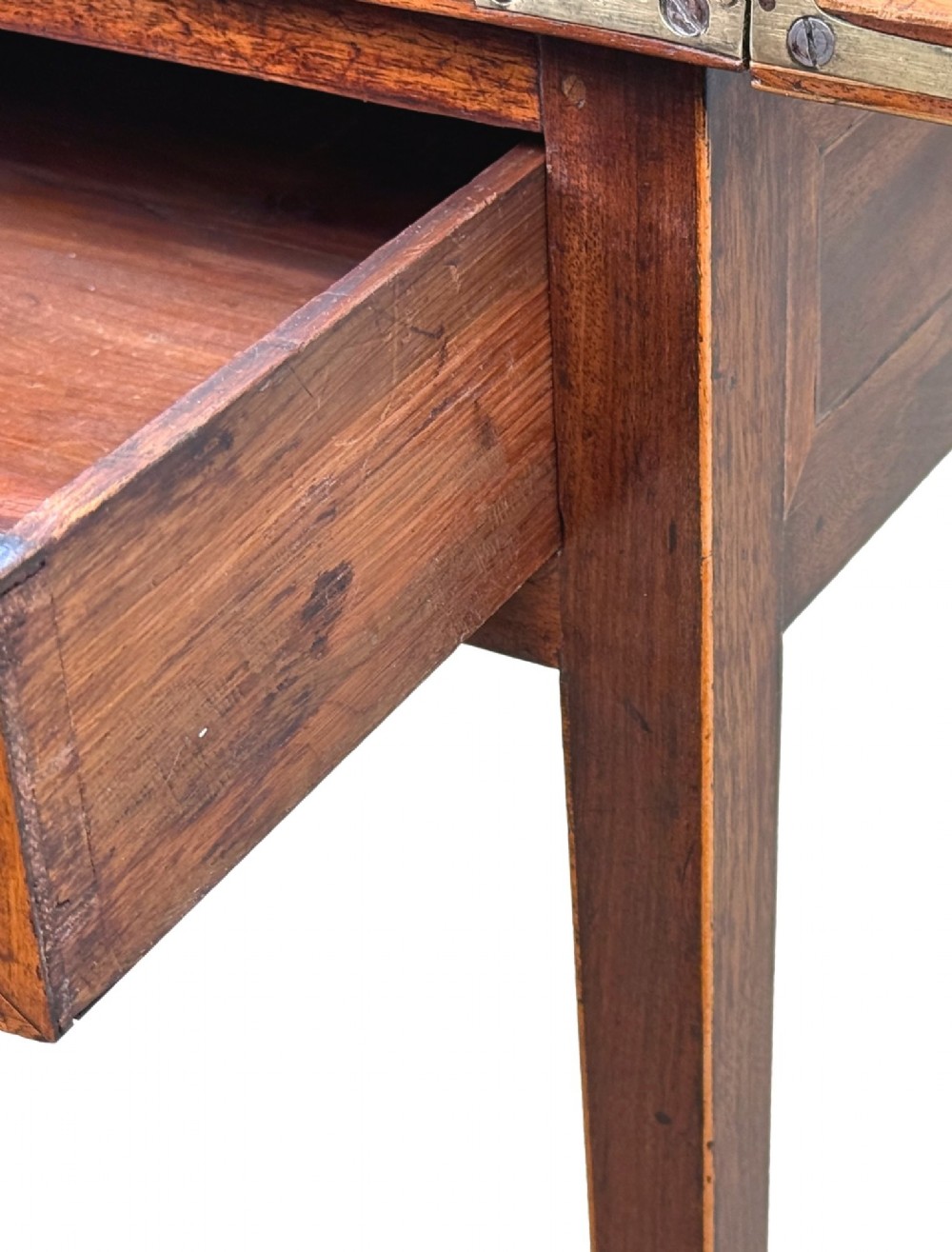 An 18th-century Georgian mahogany patience table featuring a folding top, brass corner brackets, a single drawer with ring handles, and square tapered legs. View IV