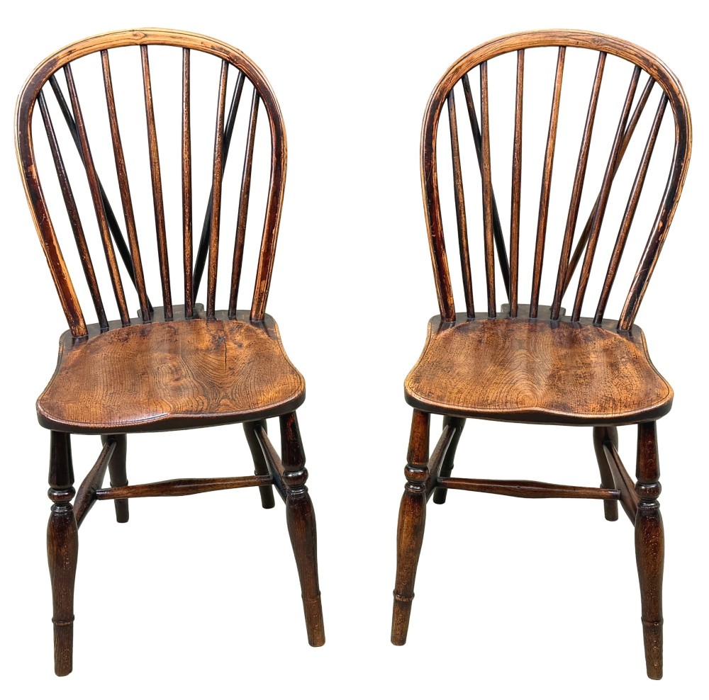 A set of six 19th-century dark wooden farmhouse dining chairs featuring hoop backs with vertical spindles and turned legs. View II