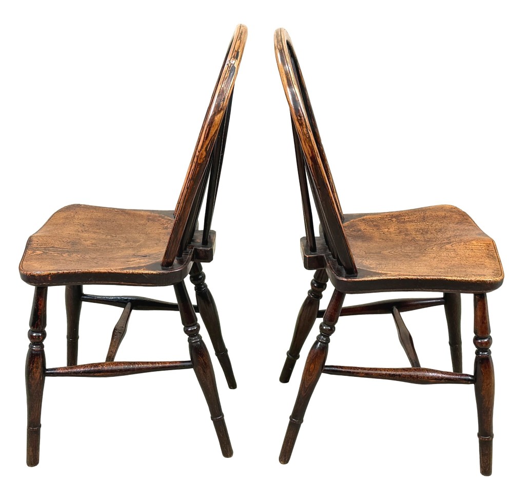 A set of six 19th-century dark wooden farmhouse dining chairs featuring hoop backs with vertical spindles and turned legs. View III