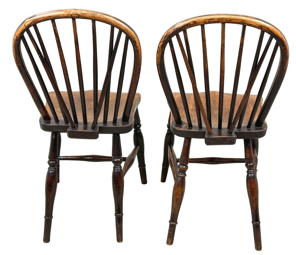 A set of six 19th-century dark wooden farmhouse dining chairs featuring hoop backs with vertical spindles and turned legs. View IV