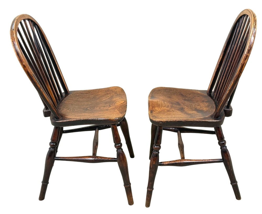 A set of six 19th-century dark wooden farmhouse dining chairs featuring hoop backs with vertical spindles and turned legs. View VII