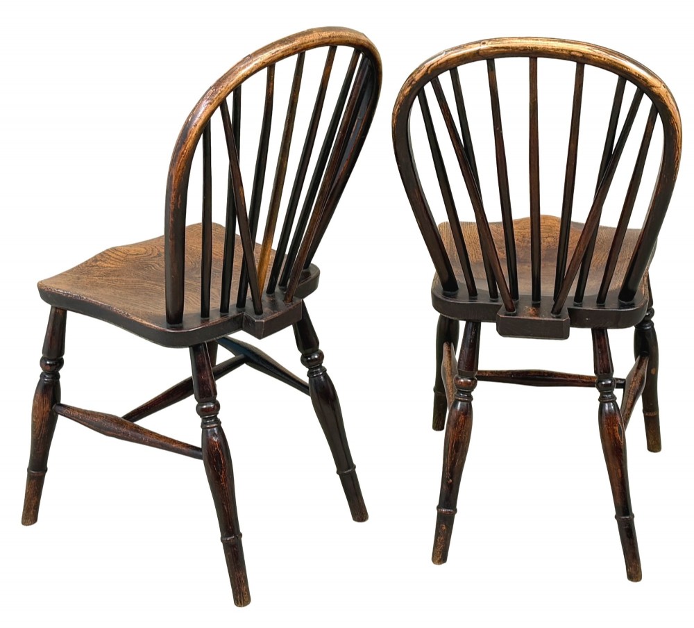A set of six 19th-century dark wooden farmhouse dining chairs featuring hoop backs with vertical spindles and turned legs. View VIII