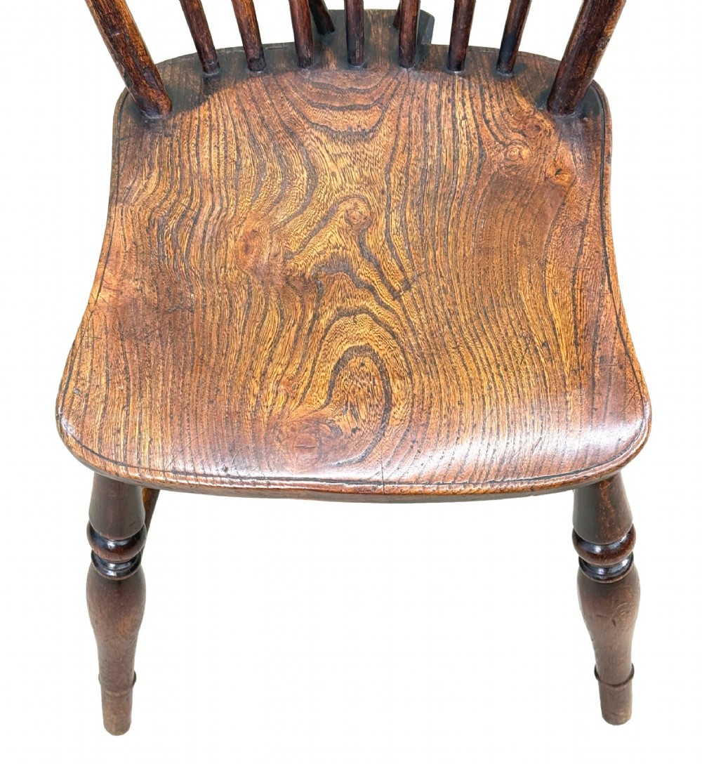 A set of six 19th-century dark wooden farmhouse dining chairs featuring hoop backs with vertical spindles and turned legs. View X