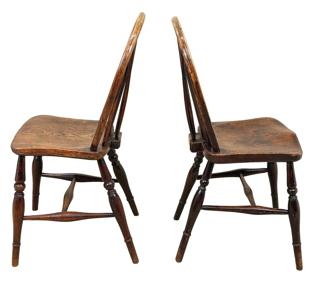 A set of six 19th-century dark wooden farmhouse dining chairs featuring hoop backs with vertical spindles and turned legs. View XII