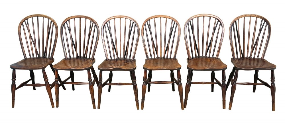 A set of six 19th-century dark wooden farmhouse dining chairs featuring hoop backs with vertical spindles and turned legs. View XV