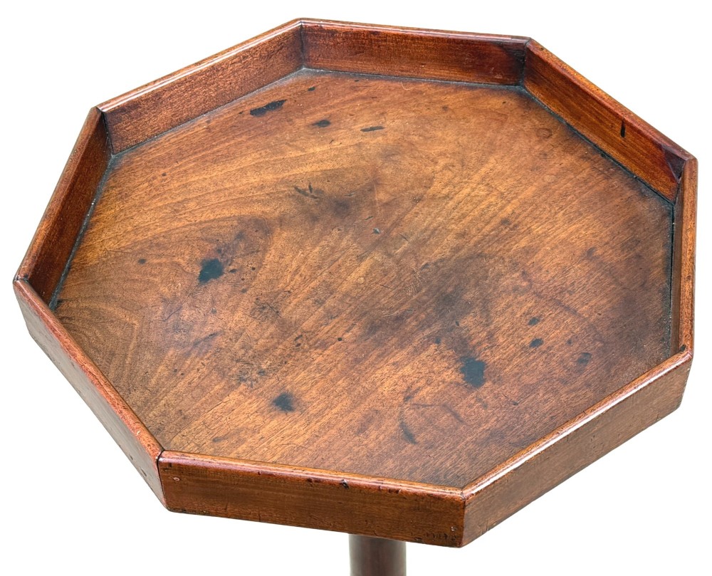 An 18th-century Georgian mahogany torchere stand featuring an octagonal tray top with raised gallery, a turned column, and a tripod base. View II