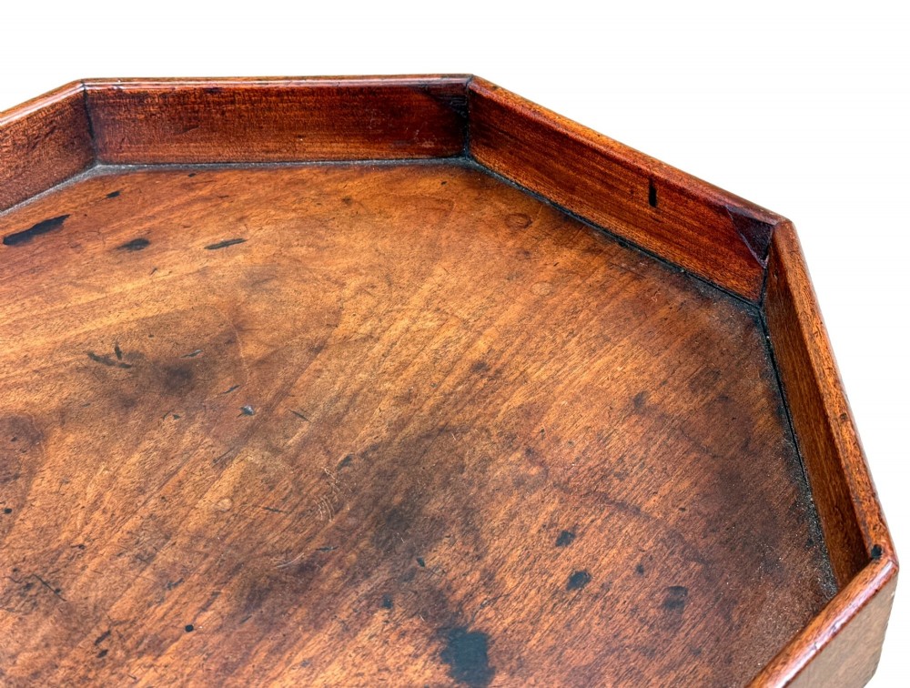 An 18th-century Georgian mahogany torchere stand featuring an octagonal tray top with raised gallery, a turned column, and a tripod base. View V