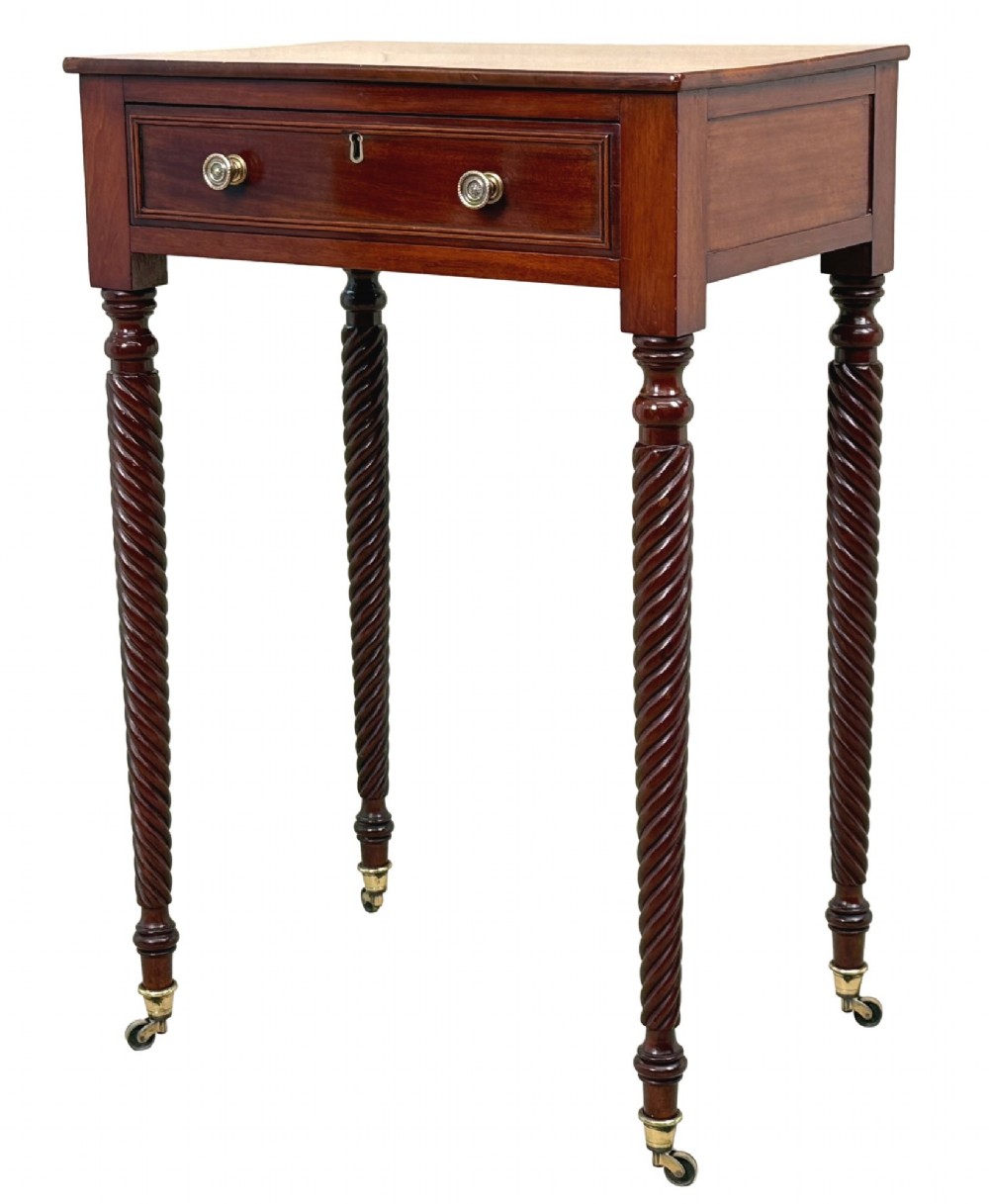 A 19th-century Regency mahogany occasional table featuring a single drawer with brass knobs, spiral turned legs, and brass castors.