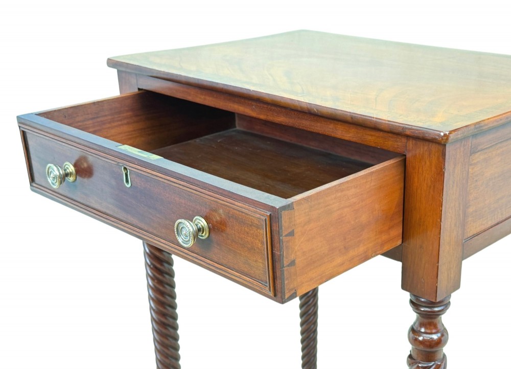 A 19th-century Regency mahogany occasional table featuring a single drawer with brass knobs, spiral turned legs, and brass castors. View III