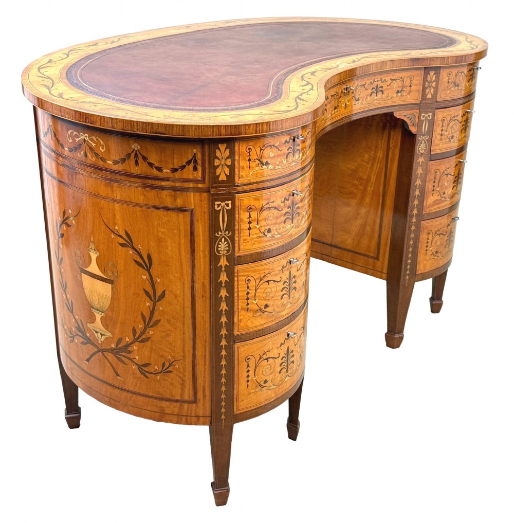 A late nineteenth-century kidney-shaped satinwood writing desk with detailed floral marquetry inlays, twin pedestals, and a leather insert top. View III