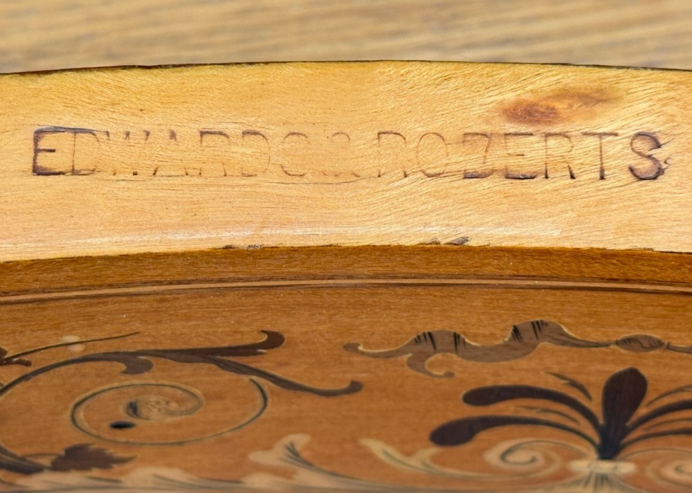 A late nineteenth-century kidney-shaped satinwood writing desk with detailed floral marquetry inlays, twin pedestals, and a leather insert top. View VI