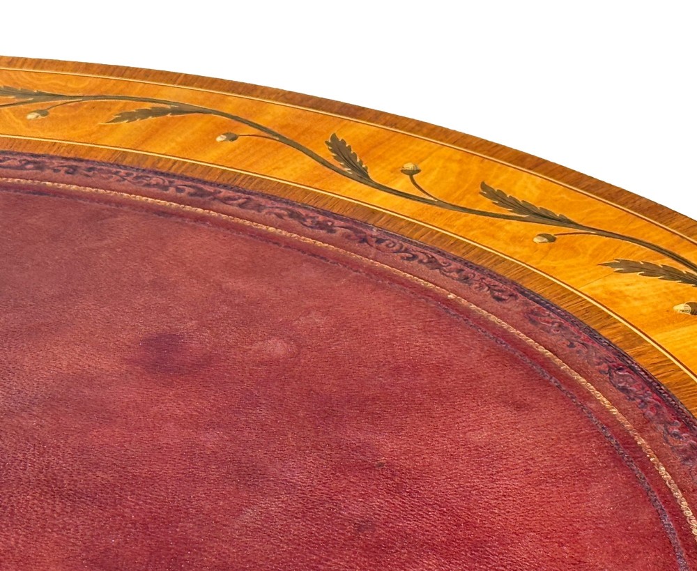 A late nineteenth-century kidney-shaped satinwood writing desk with detailed floral marquetry inlays, twin pedestals, and a leather insert top. View VII