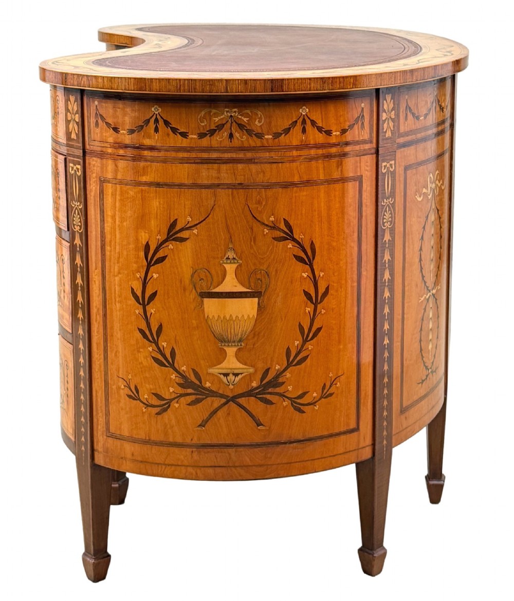 A late nineteenth-century kidney-shaped satinwood writing desk with detailed floral marquetry inlays, twin pedestals, and a leather insert top. View VIII