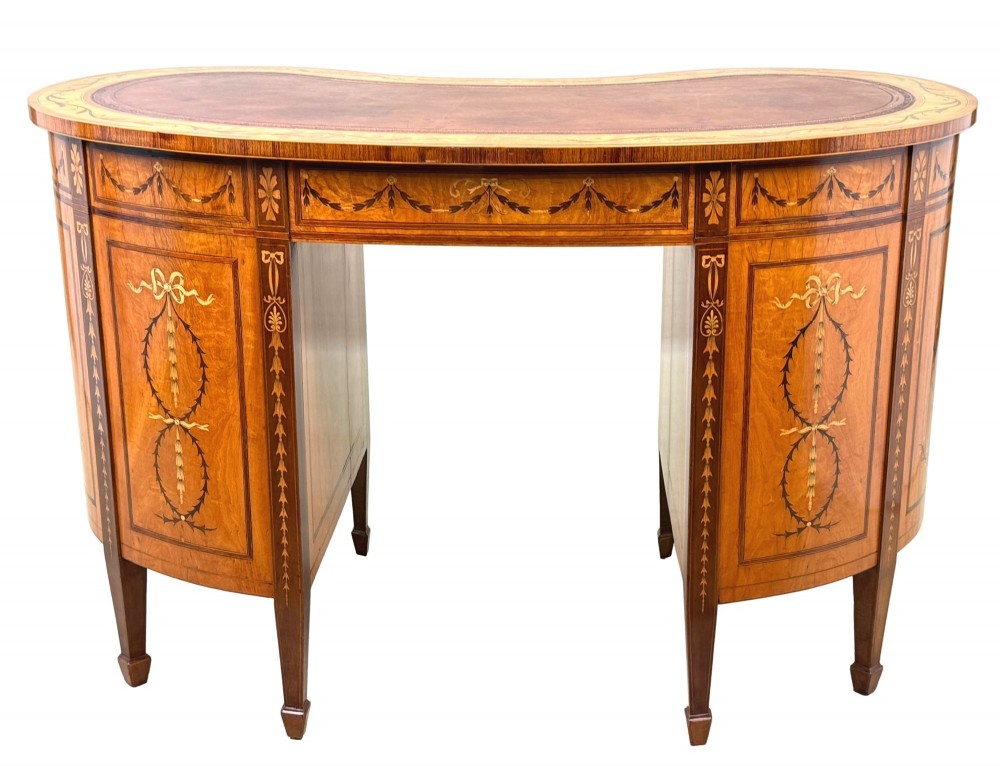 A late nineteenth-century kidney-shaped satinwood writing desk with detailed floral marquetry inlays, twin pedestals, and a leather insert top. View XIII