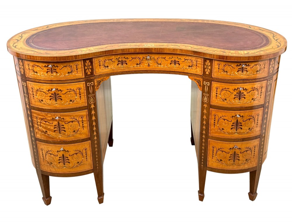 A late nineteenth-century kidney-shaped satinwood writing desk with detailed floral marquetry inlays, twin pedestals, and a leather insert top. View XIV