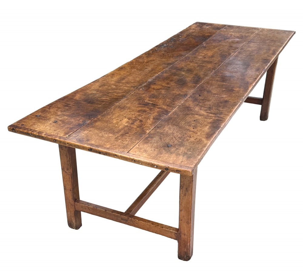 An 18th-century English farmhouse dining table crafted from warm brown oak with a wide three-plank top, plain apron, and an H-stretcher base. View III