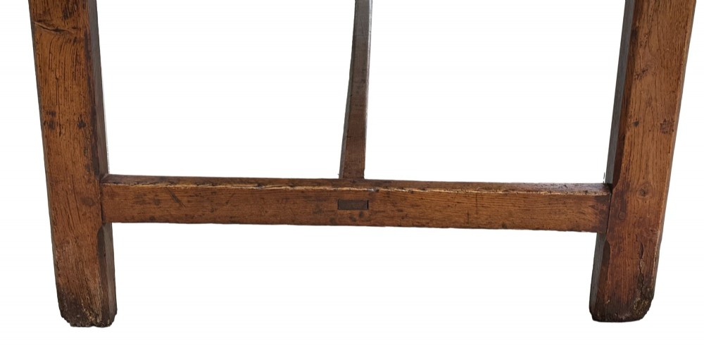 An 18th-century English farmhouse dining table crafted from warm brown oak with a wide three-plank top, plain apron, and an H-stretcher base. View VIII