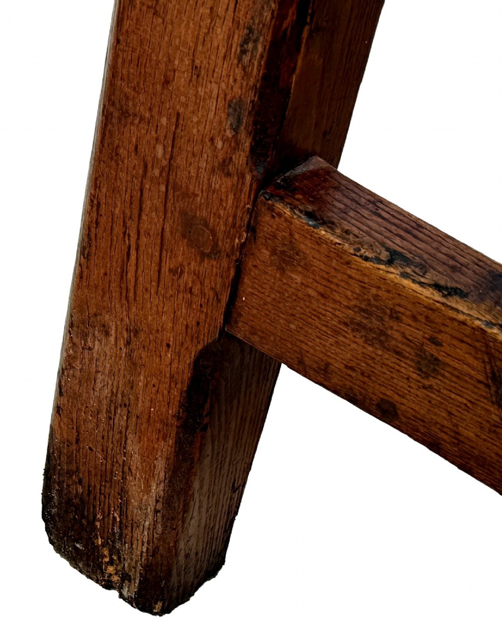 An 18th-century English farmhouse dining table crafted from warm brown oak with a wide three-plank top, plain apron, and an H-stretcher base. View X