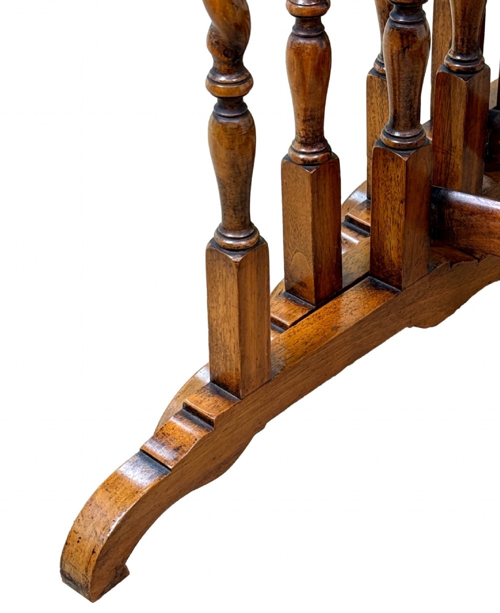 A set of four early twentieth-century brown walnut nesting tables featuring barley twist legs, arched stretchers, and banded inlaid tops stacked in graduated size. View VI
