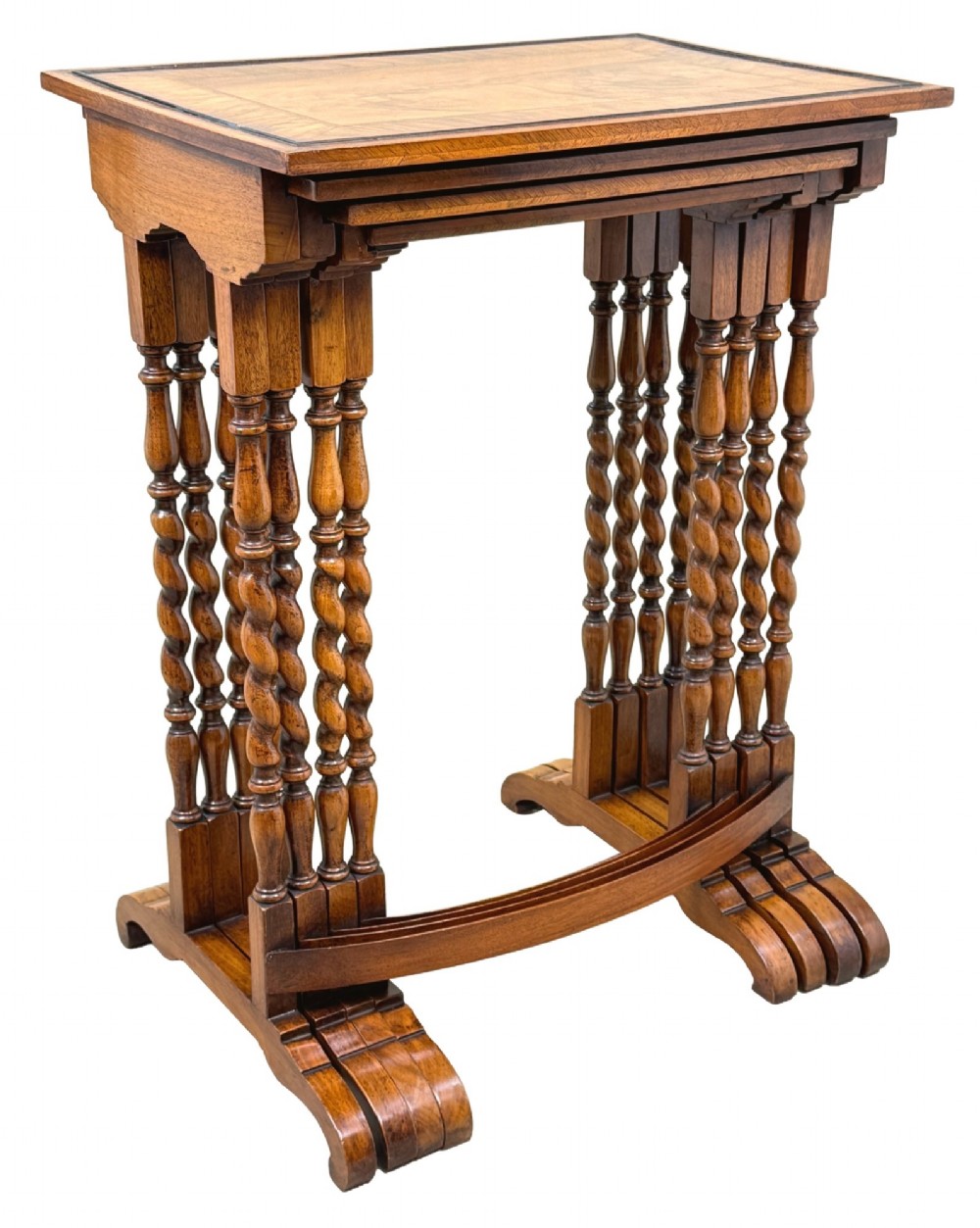 A set of four early twentieth-century brown walnut nesting tables featuring barley twist legs, arched stretchers, and banded inlaid tops stacked in graduated size. View IX