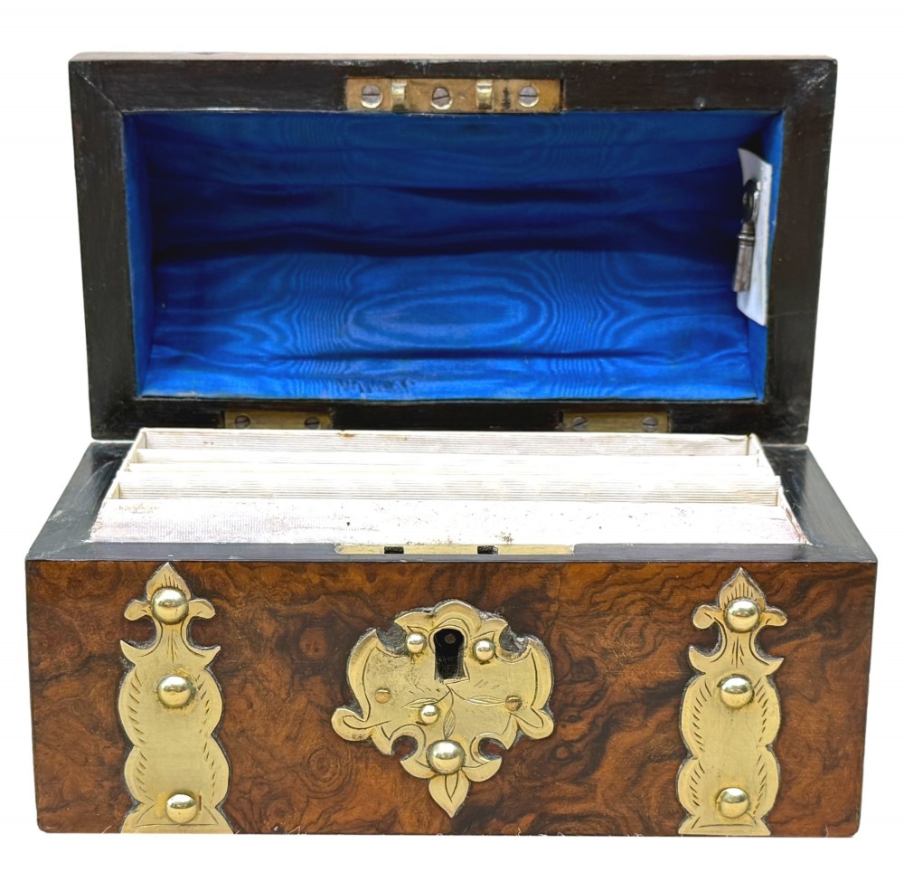 A nineteenth-century domed stationery box crafted from highly figured burr walnut with ornamental brass strapwork and studs. View III