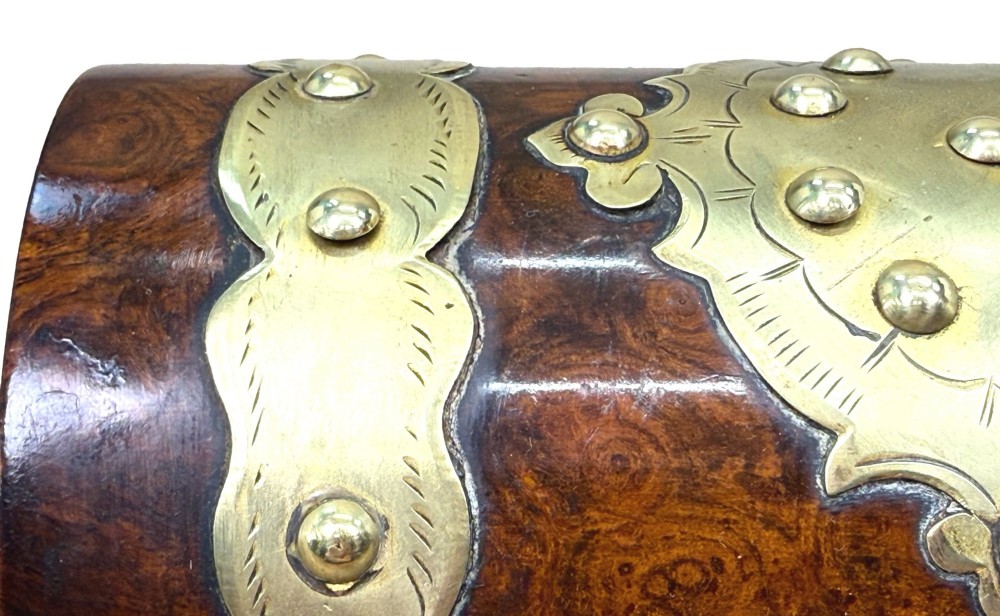 A nineteenth-century domed stationery box crafted from highly figured burr walnut with ornamental brass strapwork and studs. View V