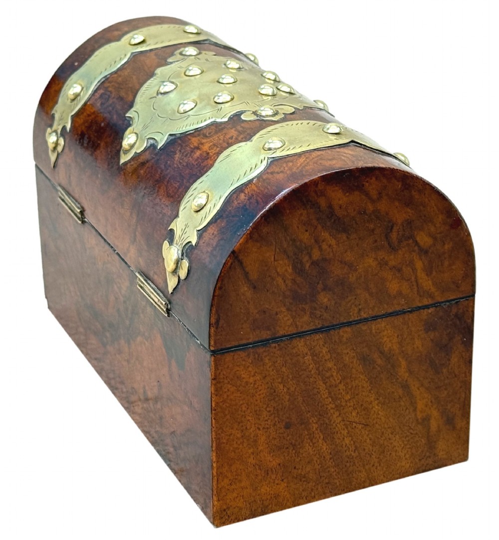 A nineteenth-century domed stationery box crafted from highly figured burr walnut with ornamental brass strapwork and studs. View VI