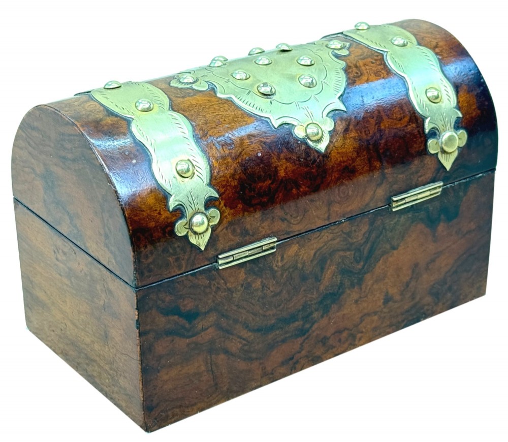 A nineteenth-century domed stationery box crafted from highly figured burr walnut with ornamental brass strapwork and studs. View VIII