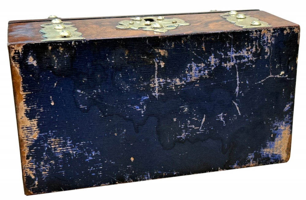 A nineteenth-century domed stationery box crafted from highly figured burr walnut with ornamental brass strapwork and studs. View IX