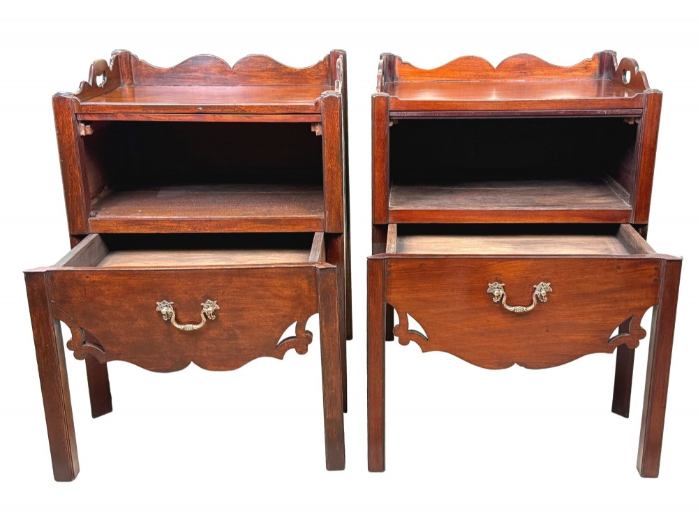 A matched pair of 18th-century Georgian mahogany bedside tables featuring scalloped tray top galleries, brass hardware, and shaped aprons. View II