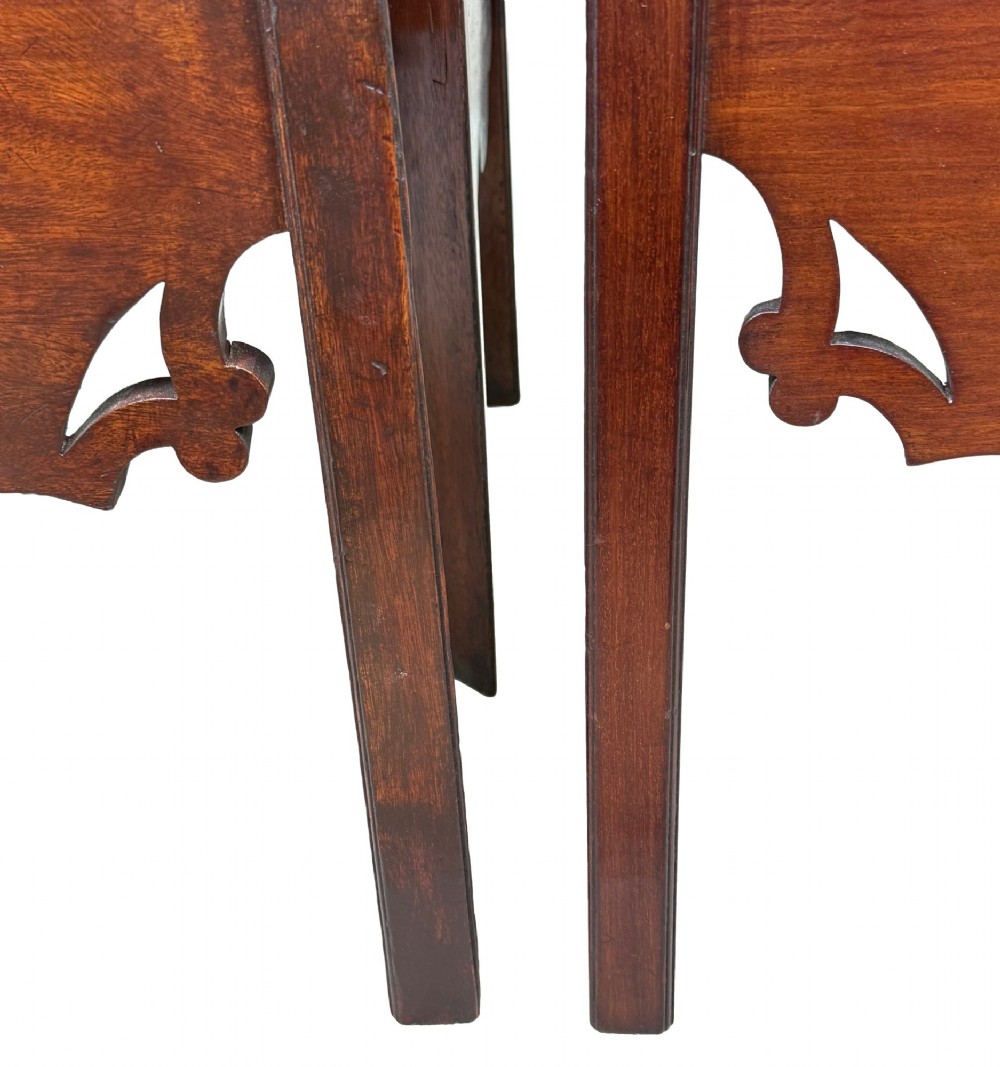 A matched pair of 18th-century Georgian mahogany bedside tables featuring scalloped tray top galleries, brass hardware, and shaped aprons. View IV
