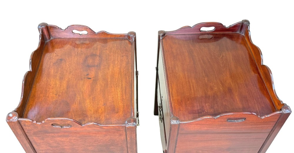 A matched pair of 18th-century Georgian mahogany bedside tables featuring scalloped tray top galleries, brass hardware, and shaped aprons. View XI