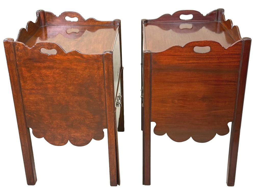 A matched pair of 18th-century Georgian mahogany bedside tables featuring scalloped tray top galleries, brass hardware, and shaped aprons. View XIII