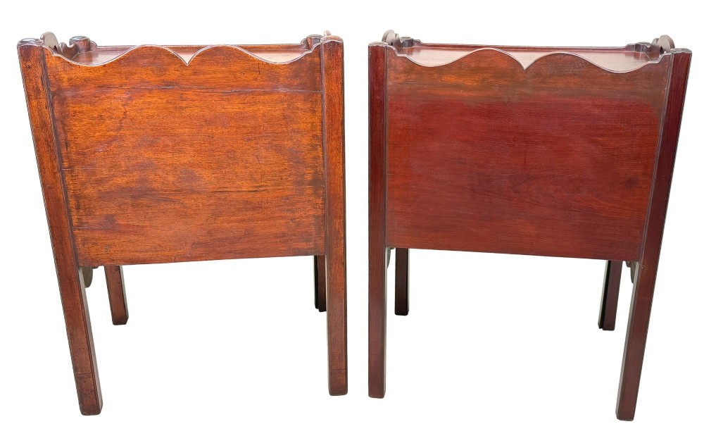 A matched pair of 18th-century Georgian mahogany bedside tables featuring scalloped tray top galleries, brass hardware, and shaped aprons. View XIV