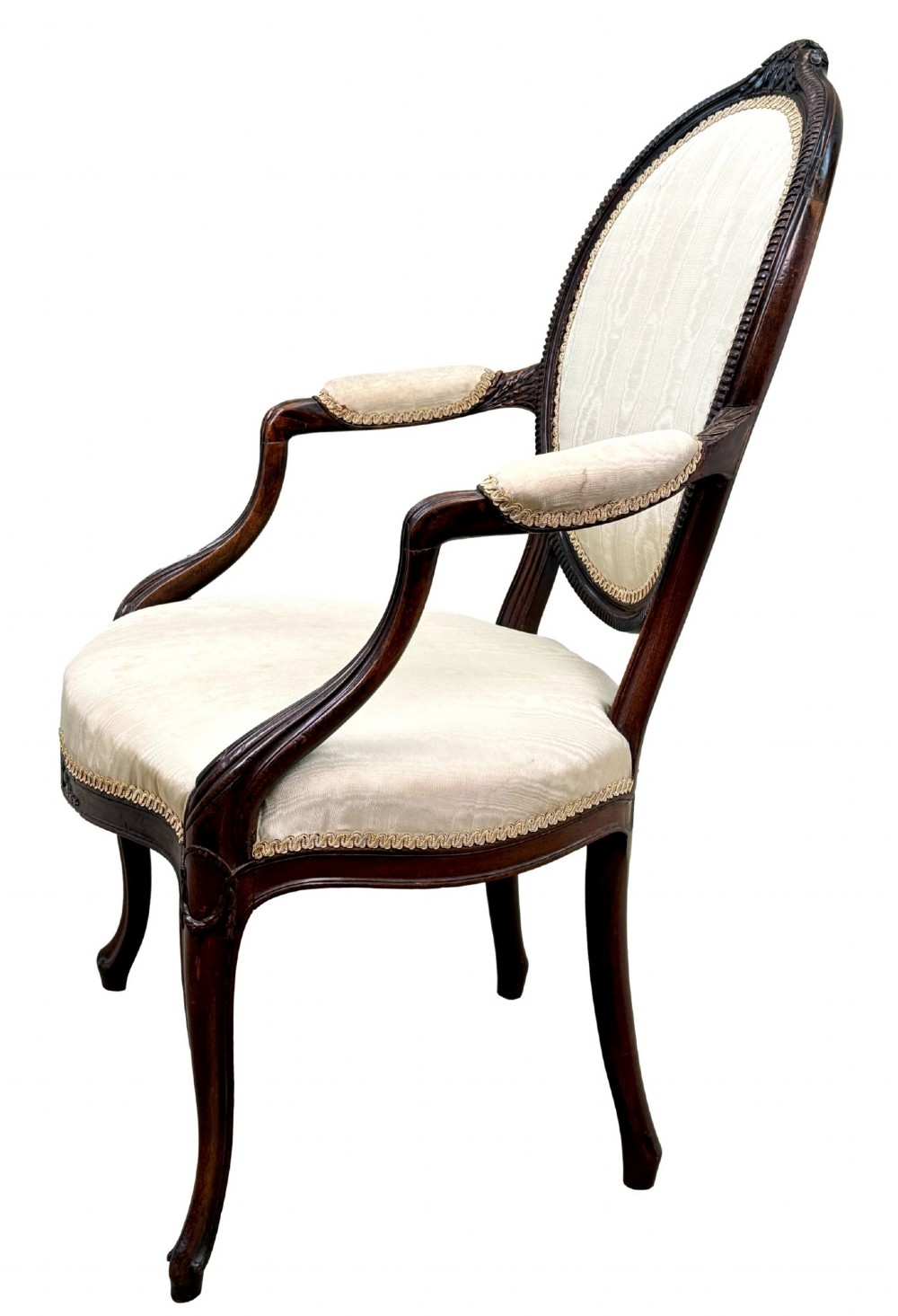 An 18th-century Georgian mahogany salon chair featuring an oval back rest, carved wooden frame, and cream silk upholstery. View VI