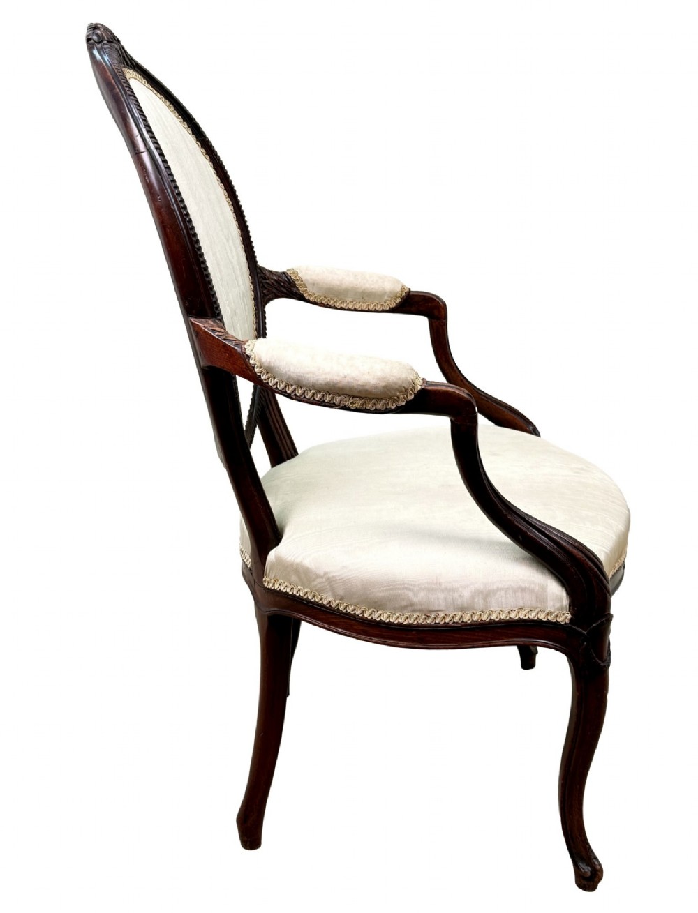 An 18th-century Georgian mahogany salon chair featuring an oval back rest, carved wooden frame, and cream silk upholstery. View VIII