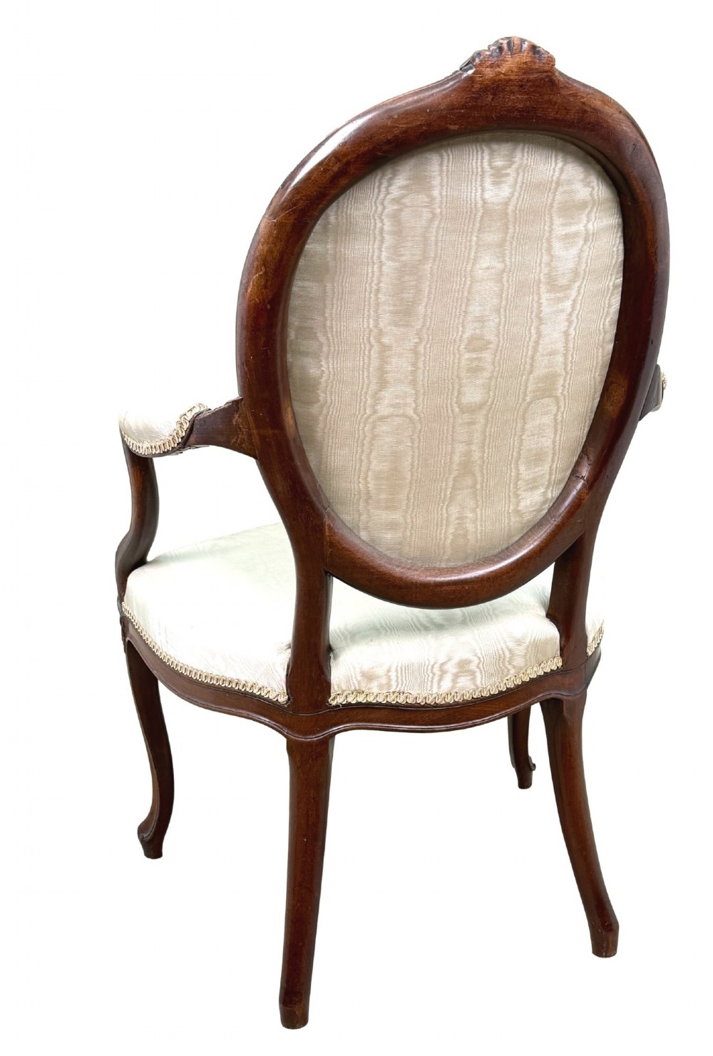 An 18th-century Georgian mahogany salon chair featuring an oval back rest, carved wooden frame, and cream silk upholstery. View XIV